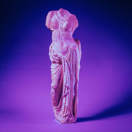 an ancient greek statue of aphrodite colored to be lit in neon purple lighting